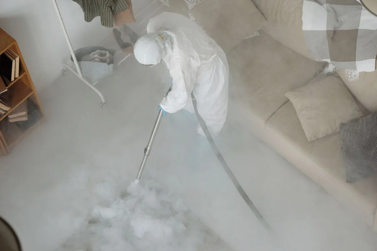 Biohazard cleanup technician in protective equipment, Overton Park, Fort Worth, TX